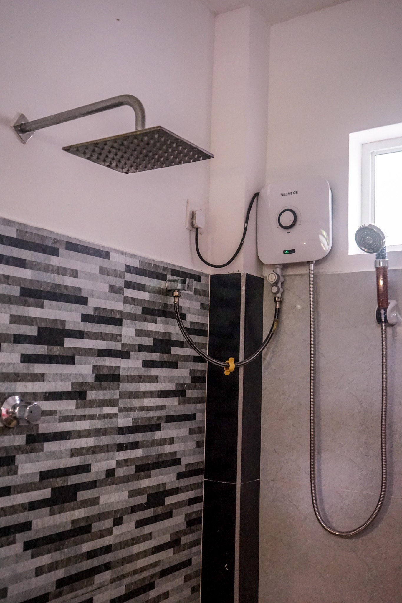 Tiled bathroom shower with rainfall head and handheld shower
